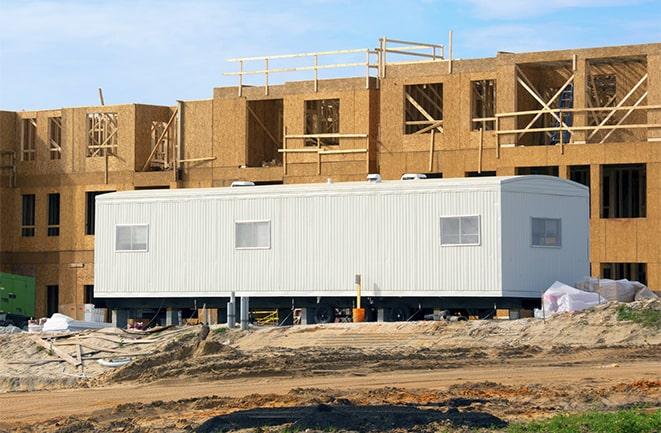 crane lifting modular building for construction office rentals in Interlachen